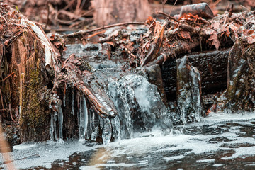 A small freezing waterfall in a winter Park.