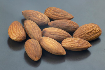 walnut almonds handful close-up on a dark plate