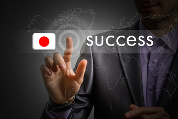 Japan success concept. Man pressing virtual button with flag icon