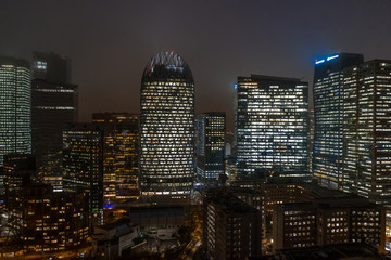Fototapeta na wymiar Aerial drone night shot of Skyscrapers with lights on in La Defense, financial district of Paris