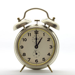 Old-style alarm clock, metal, it's one o'clock.