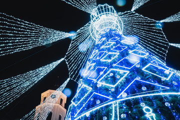 Vilnius, Lithuania, 2019: Beautiful Christmas tree decorated with white and blue lights chess queen...