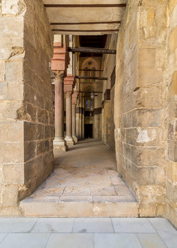 Passage at Sultan Qalawun Mosque with stone columns and colored stained glass windows, Cairo, Egypt