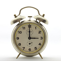 Old-style alarm clock, metal, it's three o'clock.