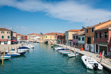 Fototapeta na wymiar Panoramic view of a channel, bridge and boats on Murano island, Venice, Italy