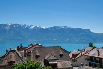 Fototapeta na wymiar Roofs of village near Geneva Lake and Alps Mountains
