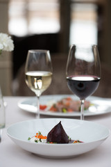 Restaurant dish and two glasses of wine