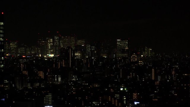 TOKYO, JAPAN - DECEMBER 2019 : Aerial high angle sunrise view of CITYSCAPE of TOKYO and Mount Fuji. View of office buildings and business district around Shinjuku. Time lapse shot night to morning.