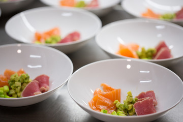 bowl of raw salad with tuna, salmon and avocado