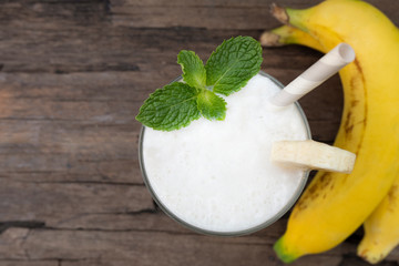 Coconut smoothies white fruit juice milkshake blend beverage healthy high protein the taste yummy In glass drink episode morning on a wooden background from top view.