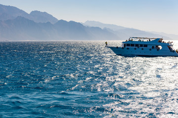 White yacht on a background of mountains. concept of sea recreation and tourism