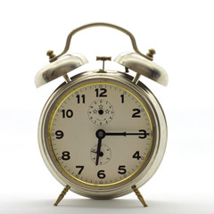 Old-style alarm clock, metal, it's quarter past six.