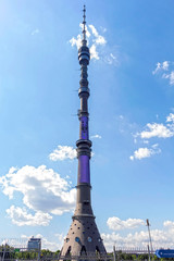 Obraz premium Ostankino TV tower on a background of blue sky with clouds