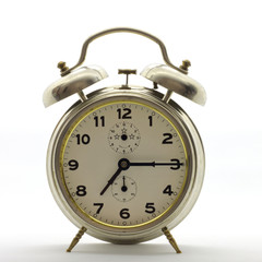 Old-style alarm clock, metal, it's quarter past seven.