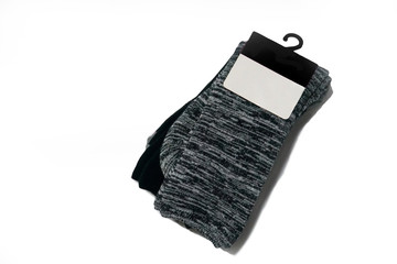 Pair of gray and black socks with label isolated white background