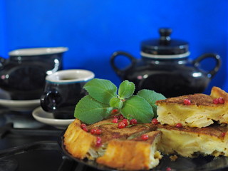 pie with apples and ice-cream of currant, with tea setz on a classic blue background