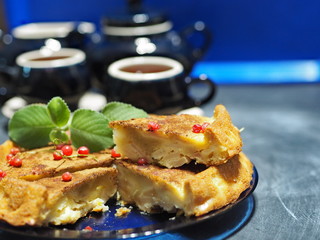 pie with apples and ice-cream of currant, with tea setz on a classic blue background