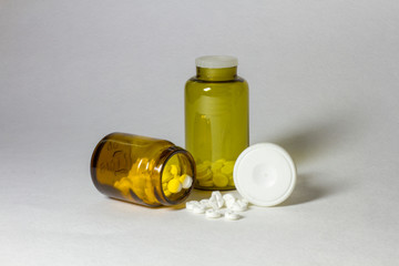 Jars of pills on a white background