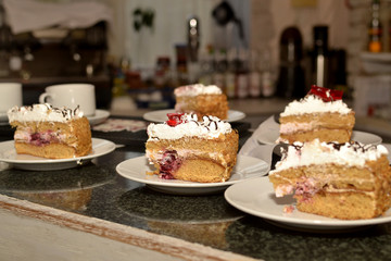 Sweet dessert, pieces of cake on plates