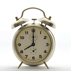 Old-style alarm clock, metal, it's eight o'clock.