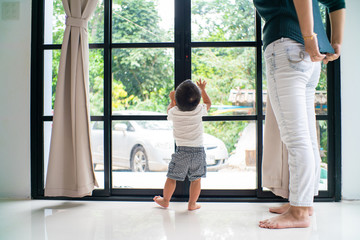 Baby toddler kids boy playing mirror window in modern house