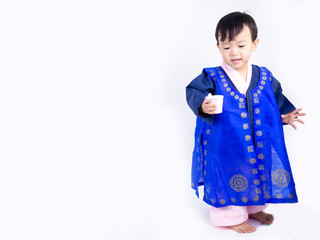 Asian little boy wearing a Korean Traditional Hanbok dress in white background