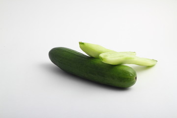 whole peeled and unpeeled fresh cucumber on white background