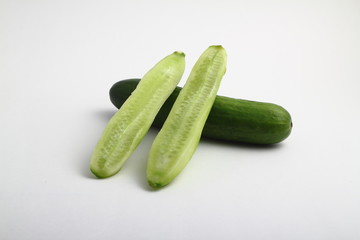 whole peeled and unpeeled fresh cucumber on white background