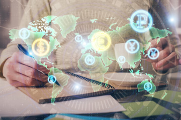 Forex chart hologram on hand taking notes background. Concept of analysis. Double exposure