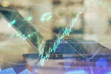 Forex graph hologram on table with computer background. Double exposure. Concept of financial markets.