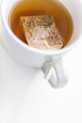 Cup of hot tea on a desk from above