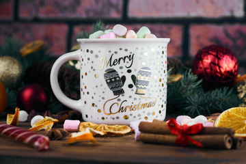 Naklejka na ściany i meble mug of hot chocolate and marshmallows. Christmas background. citrus slices, cinnamon sticks. New year table