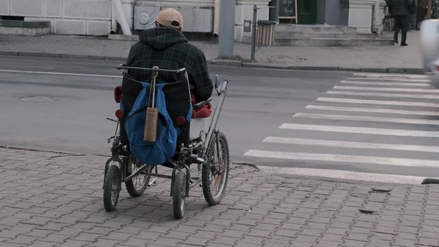 Homeless Man In A Wheelchair At The Crossing