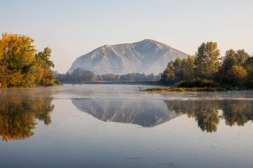 The remain of the reef of the ancient sea, composed of limestone - shikhan Yuraktau. Indian summer on the Belaya river.