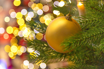 Beautiful yellow christmas ball on blurred bokeh background