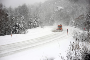 Snowplow. Forest roads full of snow and ice.