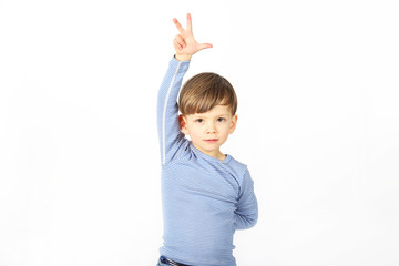 Ein kleiner Junge zeigt sein Alter von 3 Jahren