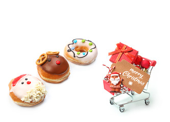 Christmas holiday concept. various set doughnuts. Christmas appetizing donuts, shopping cart, greeting tag, Santa Claus, red balls, gift box isolated on white background. holiday shopping.