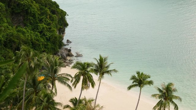 Calm sea near green jungle. Peaceful ocean with turquoise water, white sandy tropical shore in Ang Thong paradise national park, Thailand. Rainforest and rocks. Dream beach, relax and holiday concept.