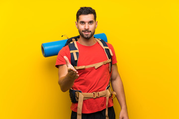 Young hiker man handshaking after good deal