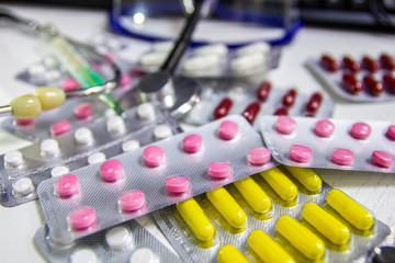 Medical and pharmaceutical concept, antibiotic pills stethoscope on the doctor’s desktop.