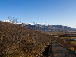 Paved trail at the beginning of the Svartifoss circular route, at the distance is the glacier tongue of Skaftafellsjökull. Skaftafell, Vatnajökull National Park, Iceland.