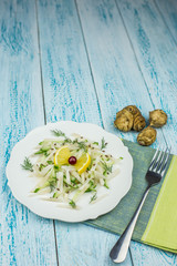 Salad of fresh Jerusalem artichoke, cucumber and lemon. Vegetarian salad with fresh vegetables. Proper nutrition at home.