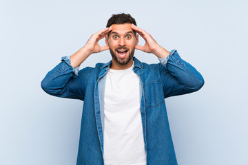 Handsome man over isolated blue background with surprise expression