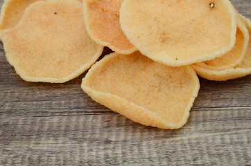 Closeup of prawn flavored chips on wooden table