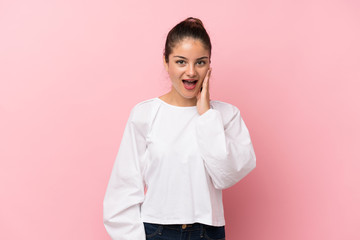 Young brunette girl over isolated pink background with surprise and shocked facial expression