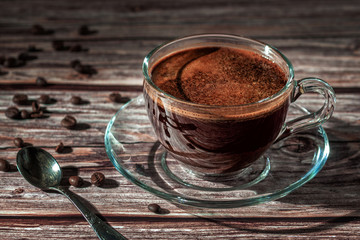Cup of fresh aromatic coffee on a wooden table