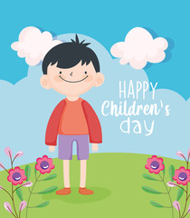 happy children day, cute little boy in the meadow with flowers