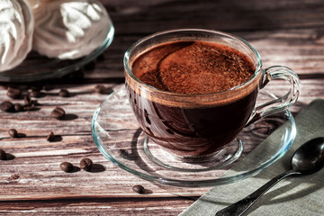 Cup of fresh aromatic coffee on a wooden table