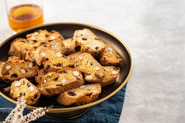 Italian almond biscotti biscuits and sweet wine in a glass on the table. Copy space.